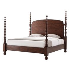 a bed with four posts and white sheets