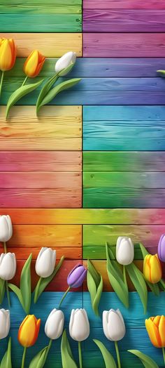 an image of colorful flowers in front of wooden planks with grass and tulips