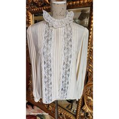 This gorgeous blouse is from the 70's by Designer Oscar de la Renta.  Made of a beige silk and lace. Flat pleats down the front with beautiful white lace insets and collar.  Buttons up the back and cuffs. Full sleeves with button cuffs. Very luxurious. The size has worn away on the tag, however, the best fit would be Large.  Please see the measurements below for a proper fit.  All sales are final. Measurements Armpit-armpit doubled 42" Shoulder 16" Sleeves 24" Length 24" Luxury Vintage Lace Blouse, Luxury Vintage Cream Blouse, Vintage Cream Tops With Lace Collar, Vintage Beige Blouse With Lace Collar, Vintage Lace Trim V-neck Blouse, Gorgeous Blouses, Pleated Blouse, Lace Inset, Lace Collar