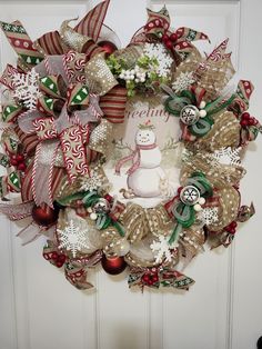 a christmas wreath with a snowman on it