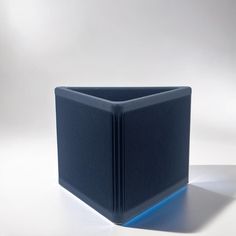 a blue square object sitting on top of a white table