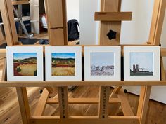 four paintings are displayed on the easel in front of an easel and other art work