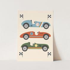 a greeting card with two racing cars on the front and one green car on the back