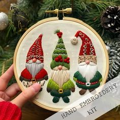 the hand embroidery kit includes three christmas gnomes