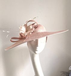 Pale pink saucer disc hat This amazing pale pink saucer disc hat is made from pink sinamay fabric. On the side are sitting matching colour feather flowers. The hat has a fabric-covered headband Pink saucer disc hat will be an amazing accessory to compliment your outfit. It will fit the average head size. You can wear this amazing hat at the wedding, Christening, Royal Ascot races, and any other special occasion. Enjoy and please have a look at my hats and fascinators in my shop  https://www.etsy Pale Pink Wedding, Pink Mother Of The Bride, Pale Pink Weddings, Sinamay Fabric, Royal Ascot Races, Mother Of The Bride Hats, Feather Flowers, Ascot Races, Royal Ascot Hats