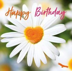 a white daisy with a heart on it's center and the words happy birthday