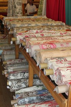 many rolls of fabric are lined up in rows