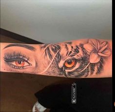 a woman's arm with an eye and tiger on it