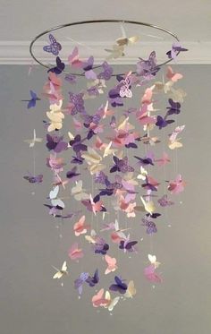 a mobile made out of paper butterflies hanging from the ceiling