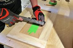 a person using a power tool to cut wood planks with a circular sawtooth