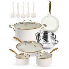 a white and gold cookware set is shown with utensils on the side