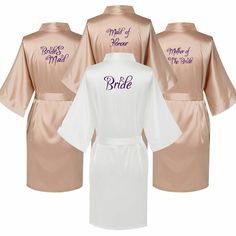 three robes with the names of bride and grooms in purple, pink and white