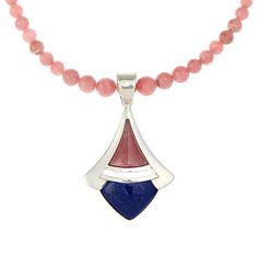 Jay King Rhodochrosite and Lapis Pendant with 24" Bead Necklace You'll be pretty in pink when you accessorize with this gemstone pendant and necklace combo from Jay King. The handcrafted sterling silver pendant pairs pink rhodochrosite with blue lapis in a fun, fashionable design that's easy to dress up or down. Also included is a rhodochrosite bead necklace to wear with the pendant or to style solo.       Pendant approx. 2-5/16"L x 1-3/8"W      Necklace approx. 24"L x 3/8"W with 2-3/4" extender Pink Round Jewelry With Gemstone Beads, Pink Round Gemstone Beads Jewelry, Round Pink Jewelry With Gemstone Beads, Pink Round Gemstone Beaded Jewelry, Pink Sterling Silver Pendant Crystal Necklace, Pink Round Pendant Jewelry With Lobster Clasp, Pink Dangle Necklaces With Gemstones, Pink Faceted Pendant Jewelry, Pink Natural Gemstones For Jewelry Making