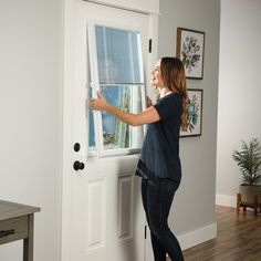 a woman is opening the door with her hand