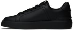 Low-top buffed calfskin sneakers in black. · Lace-up closure · Logo patch at padded tongue · Padded collar · Logo stamp at heel tab · Logo embossed at heel · Treaded rubber sole Supplier color: Noir Modern Leather High-top Sneakers With Logo Patch, Black Calf Leather Sneakers With Rubber Heel Cap, Black B, Logo Stamp, Leather Sneakers, Low Top, Patch Logo, Black Lace, Calf Skin