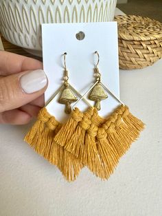 These are handmade macrame fringe earrings featuring the cutest mini mushroom charm! Perfect for those mushie lovers! These earrings are made with 100% cotton cord are available in a variety of colors! Earrings are made to order and may vary slightly due to being handmade. Posts are 18k gold hypoallergenic hooks. Size:  Total size of square earring base and fringe is 6cm x 6cm. Mushroom charm = 12mm x 15mm Color Advisory: Please keep in mind that while I try to present the colors used in every product as true to life as possible, computer monitors and phone screens may effect colors. If you have any questions regarding shades, tones and colors in general, don't hesitate to ask! Macrame Fringe, Earrings Macrame, Mini Mushroom, Gifts For Her Birthday, Phone Screens, Macrame Earrings, Handmade Macrame, Square Earrings, Earrings Boho