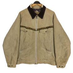 Vintage 90s Nigel Cabourn England worker jacket in beige colour. Zip up jacket with navajo pattern. Still in good condition EXCEPT slightly defect (holes) on the collar and few washable dirts. SEE THE PICTURES FOR MORE DETAILS. CONDITION : 7.9/10 MEASUREMENT Pit : 27 inch Length : 27 inch Shoulder : 23 inch Sleeve : 23 inch Size On Tag : 3 Recommended Size : L-XL PAYMENT We accept PayPal only. The item will be ship 3-5 days once the payment has been made. NORMAL SHIPPING FEDEX USUALLY AROUND 7-2 Western Style Long Sleeve Cotton Outerwear, Western Style Long Sleeve Denim Jacket, Bohemian Beige Outerwear With Pockets, Vintage Brown Denim Jacket For Winter, Vintage Fall Outerwear For Ranch, Retro Long Sleeve Outerwear For Rodeo, Vintage Long Sleeve Outerwear For Rodeo, Workwear Casual, Navajo Pattern