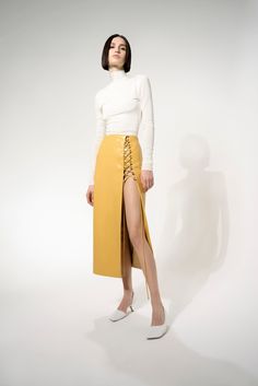 This Two Layer skirt emphasize the leg-lengthening effect. designed to be worn at the waist. Designed in a firm, non-stretchy vegan leather, with a lace-up front slit that fits true to size. Dress up or dress down in your favorite top or sweater for a cool look. -- Product Details Composition: Polyester 50% Polyurethan 50% Lining: Polyester 100% Yellow Vegan Faux Leather True to Size Midi Length Lace-Up Front Slit Leg-Lengthening Design Vegan Leather Midi Skirt, Back Stretches, Leather Midi Skirt, White Turtleneck, Draped Skirt, Power Dressing, Womenswear Fashion, The Genius, Plaid Blouse