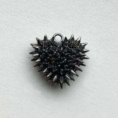 Make a statement with the Micro Spiked Heart Necklace by Bunny Paige. Handcrafted in Cleveland, the pendant features 100 micro spikes each applied by hand to a resin base. This pendant is perfect for everyday wear, adding a touch of edge to any outfit. DETAILS Heart Charm: .75” wide Chain: 18” chain SIZE CHART Black Spiked Jewelry Gift, Black Spiked Jewelry For Gifts, Black Spiked Jewelry As Gift, Punk Style Studs Jewelry For Gifts, Chain Size Chart, Metal Jewelry Handmade, Alternative Jewelry, Gold Heart Necklace, Funky Jewelry