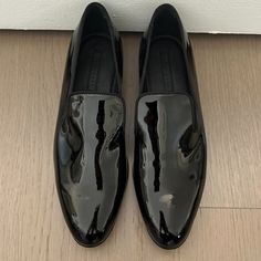 Hugo Boss - Black, Patent Leather Slipper Sophisticated, Sleek, Black Patent Leather Slip On Loafer With Silk Grosgrain Ribbon Trim Covering All Edges. Seamless Flat Front With An Almond Shaped Toe, Lightly Padded Footbed And Notches On Each Side Of The Tongue Giving You That Fashionable Slipper Look. Leather Upper. True To Size. Made In Italy. Never Worn. No Box. Smoke Free, Pet Free Home. Luxury Patent Leather Loafers With Leather Footbed, Hugo Boss Woman Shoes, Black Slip-on Dress Shoes For Formal Occasions, Sleek Patent Leather Dress Shoes For Evening, Elegant Fitted Patent Leather Loafers, Black Almond Toe Dress Shoes For Spring, Hugo Boss Shoes Women, Sleek Black Patent Leather Loafers, Classic Patent Leather Party Loafers