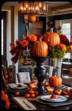 a dining room table set with pumpkins and candles