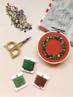 sewing supplies are laid out on a table with scissors, thread and spools