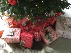 presents under the christmas tree are wrapped in red and white paper