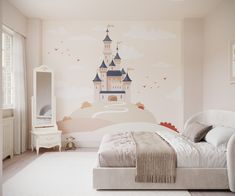 a child's bedroom with a castle mural on the wall