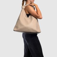 The Como Shoulder Bag by Urban Originals is a stylish double knot hobo crafted from woven vegan leather. Designed to be roomy, it effortlessly accommodates your everyday essentials with flair. Intrecciato Weave Hobo Shoulder Bag For On-the-go, Woven Leather Hobo Tote Bag For On-the-go, Versatile Woven Leather Shoulder Bag For Everyday Use, Versatile Leather Bucket Bag With Braided Handles, Everyday Beige Bag With Intrecciato Weave, Casual Shoulder Bag With Intrecciato Weave For Errands, Modern Woven Leather Bucket Bag For Errands, Versatile Woven Leather Bucket Bag For Travel, Versatile Everyday Bag With Woven Leather