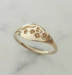 Elegant and unique 14k gold May birth flower signet, Lily of the valley wide signet ring. * Band width: 1.5 mm, wide part width: 7.5 mm * Thickness: 1.5 mm * Available in 14K or 18K YELLOW, WHITE and ROSE gold. The price listed is for 14K please contact me for 18K pricing. * Sizes vary from 5 US to 9 US, including half sizes. Please choose your size upon checkout. * Please choose a finish: Shiny or Matte, and mention in note to seller. * This item is handmade, please allow 3-6 weeks of processin Lily Of The Valley Ring, May Birth Flower, Flower Wedding Band, May Birth Flowers, Floral Wedding Bands, Signet Rings Women, Engraved Flower, Fine Gold Jewelry, Birth Flower