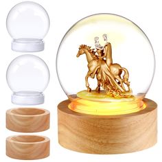 a snow globe with a horse and rider in it on top of a wooden stand