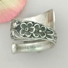 Kirk silverware mfg has been well known for their Lavish wildflower patterns in the Repousse style. This antique 1828 pattern ring is pictured as made in size 8. I can custom size this ring from size 8 up to size 13. Ring is made from a full size sterling silver tea spoon, and is 1/4 inch wide at narrowest back section, and 7/8 inch at widest front section. Ring band is 1/16- inch thick. Inside ring band is smooth, making for a comfortable fit. Ring weighs 16 grams of sterling silver. A garden f Vintage Flower Engraved Ring For Anniversary, Vintage Silver Flower Ring For Gift, Vintage Silver Flower Ring Gift, Silver Vintage Flower Ring For Gift, Vintage Engraved Flower Ring For Gift, Vintage Engraved Flower Ring Gift, Vintage Silver Flower Ring Stamped 925, Vintage Flower Ring Stamped 925, Heirloom Style Silver Flower Ring For Anniversary