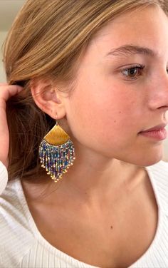 Woman wearing gold beaded fringe earrings with multi colored beads. Elegant Multicolor Beaded Earrings With Fringe, Multicolor Beaded Fringe Earrings With Unique Style, Multicolor Fringe Beaded Drop Earrings, Gold Artisan Beaded Fringe Earrings, Unique Multicolor Beaded Fringe Earrings, The Fringe, Handmade Beaded Jewelry, Drop Beads, Pattern Ideas