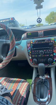 the interior of a car decorated with stickers and fabric, including steering wheel controls