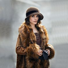 a woman wearing a fur coat and hat