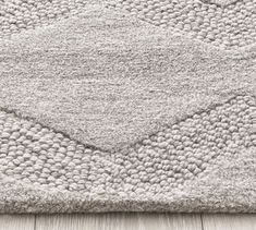 an area rug with white and gray colors