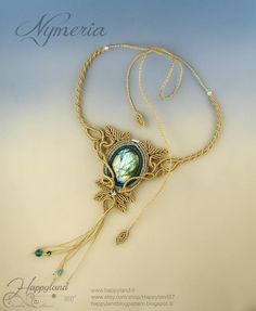 the necklace is adorned with an ornate design and features a green glass cabochon