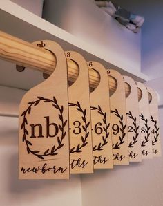 six wooden hangers with numbers and leaves on them