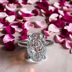 an oval cut diamond surrounded by pink petals