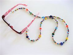 "Colorful and fun Beaded Eyeglass Chain, and Necklace combination handmade by Ralston Originals. This is a unique original style Eyeglass Chain and Necklace combination designed by Ralston Originals. Unique from any other Eyeglass Chains on Etsy, Ralston Originals was the first to add the lobster clasp at the end of the chain to join together to make a Necklace. Brilliant! This makes it even more unique because you now have two pieces of jewelry in one!!. Wear it to work or out shopping as a Nec Colorful Adjustable Glass Beaded Necklaces, Fun Adjustable Beads For Gifts, Handmade Colorful Glass Beaded Necklaces, Colorful Handmade Glass Beaded Necklaces, Multicolor Handmade Glass Beads, Multicolor Beaded Chain Glasses Chains For Gifts, Multicolor Beaded Glasses Chain For Gift, Multicolor Beaded Glasses Chain As Gift, Handmade Round Glass Beads