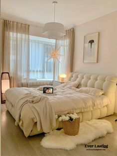 a bedroom with a large bed and white fur rugs