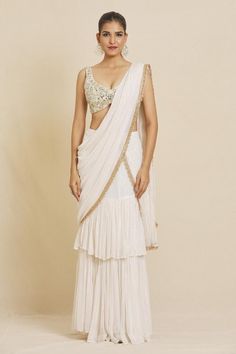 Ivory pre-stitched stripe pattern ruffle saree, accentuated with an embroidered border and pearl embellishments. Paired with a hand embroidered blouse in mirror and pearl work. - Aza Fashions Bollywood Style White Pre-draped Saree With Pearl Embroidery, Festive White Pre-draped Saree With Pearl Embroidery, Traditional Georgette Pre-draped Saree With Pearl Embroidery, Designer Pre-draped Georgette Saree With Pearl Embroidery, Designer Pre-draped Saree With Pearl Embroidery, Designer Pre-draped Fitted Saree With Pearl Embroidery, Designer Pre-draped Pearl Embroidered Saree, Designer Fitted Pre-draped Saree With Pearl Embroidery, Traditional Pearl Embroidered Pre-draped Saree For Festive Occasions