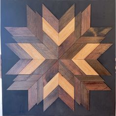 a wooden wall hanging with several different colored wood pieces in the shape of an arrow