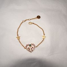 The Dior In Heart Lights Bracelet Combines The Heart, A Symbol Cherished By The House, With Seasonal Colors(Pink, Green, Red). The Gold-Finish Metal Chain Features Two Stars And Is Embellished With A Multicolor Heart With A Crystal Pave. Delicate And Elegant, The Bracelet Can Be Paired With Other Dior In Heart Lights Creations Total Length Measure: 8" Brand New. Comes With White Dust Bag Luxury Heart Bracelet As A Gift, Luxury Heart Cut Bracelet As Gift, Luxury Heart Cut Bracelet For Gift, Luxury Heart-cut Bracelet For Gift, Luxury Adjustable Heart Bracelet, Luxury Adjustable Heart-shaped Bracelet, Luxury Adjustable Heart-shaped Jewelry, Luxury Gold Bracelet For Valentine's Day Gift, Luxury Heart-shaped Gold Bracelet Gift