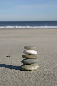 some rocks stacked on top of each other in the sand