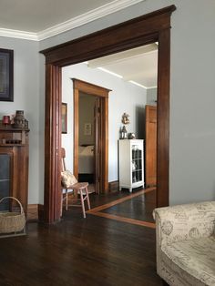 a living room filled with furniture and a fire place under a mirror on the wall