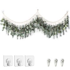 an assortment of green and white flowers hanging from the side of a wall next to three pairs of earrings