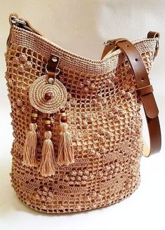 a brown purse with tassels on it