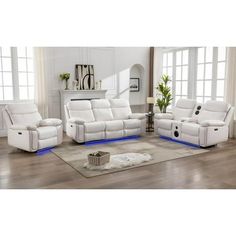 a living room filled with white furniture on top of a hard wood floor