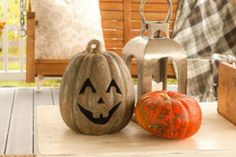 two pumpkins are sitting on the porch with their faces carved into them, and one is